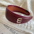 Detail of burgundy leather headband featuring a rhinestone letter E ornament on the side - Rhinestone Letter Decoration (E) / Burgundy