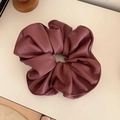 Detailed view of dark red leather scrunchie with elegant pleated texture and premium finish - Ankora Red