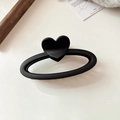 Detail shot of a matte black heart-shaped hair claw clip on a minimalist background - Black