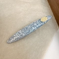 Close-up of spindle hair clip in grey-blue resin with iridescent shell inlay and logo - Blue (D-4735-3)