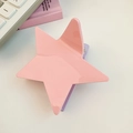 Macro shot of pink five-pointed star hair claw clip with glossy resin finish - Pink