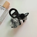 Elegant vintage camellia shark clip with black resin rose and pearls on cream background - Hair Claw