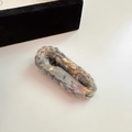 Pinza para el pelo tejida en gris con pompones arcoíris sobre un fondo blanco - Gris (D-4682-2)