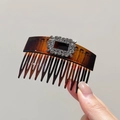 Detail view of brown tortoiseshell hair comb with a sparkling rectangular rhinestone buckle - Caramel color