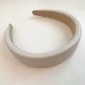 Detail of light grey padded PU leather headband featuring a non-slip brown inner lining - Beige