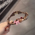 Close-up of leopard print hair claw clip featuring cute pink dog and gemstone charms - Leopard Puppy Style (D-5998-1)