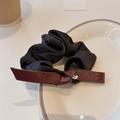 Elegant black satin scrunchie with a burgundy leather bow and silver letter pendant charm - Versatile Black