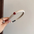 Detail view of handmade beige satin headband with a red heart and handmade label - Beige (D-5538-5)