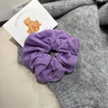 Detail of purple terry cloth scrunchie with translucent charm on knit background - Purple Scrunchie