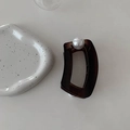 Detail view of large amber translucent hair claw clip with a decorative oversized white pearl - Coffee (D-4207-2)
