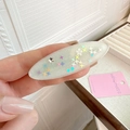 Macro shot of oval duckbill clip in cream with glitter and colorful star patterns - Cream Oval Star Style (D-4401-4)