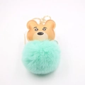 Close-up of a brown leather bear charm attached to a mint green fluffy pom pom keychain - Gold Keychain / Mint Green