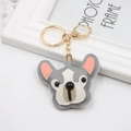 Close-up of grey and white leather bulldog keychain with golden lobster clasp and stitching - Bulldog / Gray