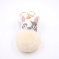 Detail of cute bulldog plush keychain with soft faux fur pompom and golden lobster clasp - Off-white