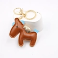 Portachiavi cavallo in pelle marrone con finiture dorate e dettagli in camoscio blu - caffè