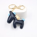 Dettaglio portachiavi a cavallo in pelle blu scuro con finiture dorate e cuciture a mano - Blu Notte