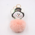 Close-up of pink pom pom snowman keychain with golden metal ring and red berry detail - Pink