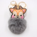 Close-up of cute cartoon deer keychain with gray faux fur pompom and gold lobster clasp - Gray