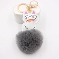 Detailed view of white lucky cat keychain with grey fluffy pompom and gold hardware - Gray