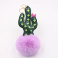 Detail of faux leather cactus keychain featuring pink bow and purple fluffy pompom - Cactus Gold Keychain / Taro Purple