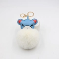 Close-up of cute blue leather bear keychain with soft white faux fur pompom and gold clasp - Off White