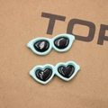 Detail view of heart and oval resin sunglasses charms in mint green for DIY crafts - Heart Shape / Mint Blue