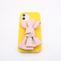 Detailed view of large pink PU leather bow accessory attached to yellow iPhone phone case - Single Bowknot Accessory / Pink