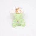 Detail of mint green leather bear keychain with gold hardware and engraved silver tag - Matcha Green