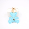Close-up of light blue leather bear keychain with golden charm and detailed stitching - Light Blue