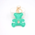 Detail of mint green leather bear keychain with golden ring and zircon charm - Green