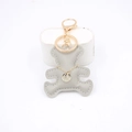 Gray leather bear keychain charm with gold decorative chain and sparkling pendant on stand - Gray