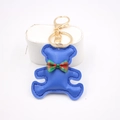 Close-up of cute bright blue leather bear keychain with red and green plaid bowtie - Bear Charm / Sapphire Blue