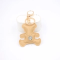 Detailed view of a khaki leather bear keychain with gold clasp and chain necklace decor - Khaki