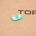 Close-up of mint green silicone rabbit ear shoe charms with white inner detail - Green
