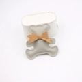 Detail of a handmade grey leather bear charm with a brown bow and white stitching - Gray