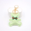 Detail of light green faux leather bear keychain with tartan bow and golden lobster clasp - Bear Charm / Matcha Green