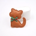 Detail of a brown leather cat charm with a green and red plaid bow tie and neat stitching - Coffee
