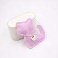 Macro shot of light purple leather cat charm with fine stitching and gold plate details - Taro Purple
