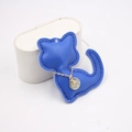 Detail of blue cat leather pendant with gold metal tag and decorative stitching - Sapphire Blue