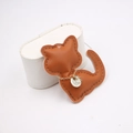 Detailed view of a handmade brown leather cat pendant with fine stitching and gold chain - Coffee