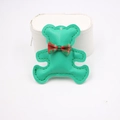Detail of green leather bear phone charm with red-green plaid bow on white stand - High-end Style (Bear Accessory) / Green