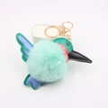 Macro view of mint green hummingbird plush keychain with leather wings and gold clasp - Mint Green