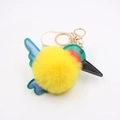 Detail of yellow plush hummingbird keychain with colorful PU leather wings and gold clasp - Yellow