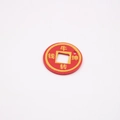 Close-up of red leather pendant with gold embossed Chinese characters on white background - Ox Fortune
