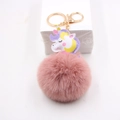 Detailansicht eines rosa Plüsch-Schlüsselanhängers mit Einhorn-Lederanhänger und Goldring - Altrosa