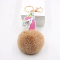 Close-up of holographic unicorn keychain with fluffy brown faux fur pom pom and gold ring - Unicorn Fur Ball Charm / Khaki