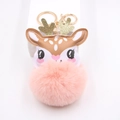 Detail of cute reindeer plush keychain with pink pompom and sparkling golden antlers - Pink