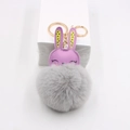 Close-up of cute purple leather rabbit with fluffy grey fur ball pompom keychain - Light Gray