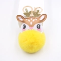 Close-up of yellow plush reindeer keychain with golden antlers and metallic hardware - Yellow