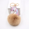 Unicorn plush ball keychain with printed leather head and golden metal clasp on white stand - Khaki